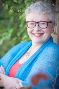 Dr Jane Lewis headshot with garden background